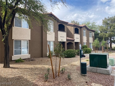 View of front of house with stucco siding and a tile roof