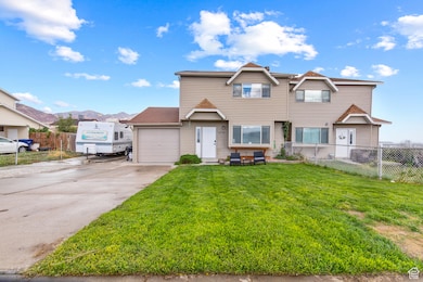 Home with concrete driveway, an attached garage, and a mountain view