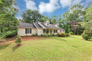 Cape cod-style house with a front yard