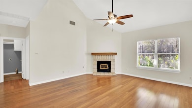 Unfurnished living room with high vaulted ceiling