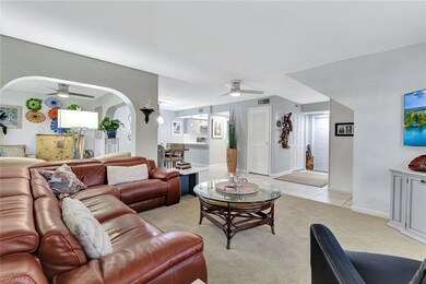 Living room with arched walkways, light tile patte