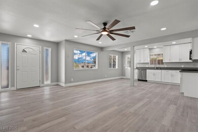 Unfurnished living room with recessed lighting, ba