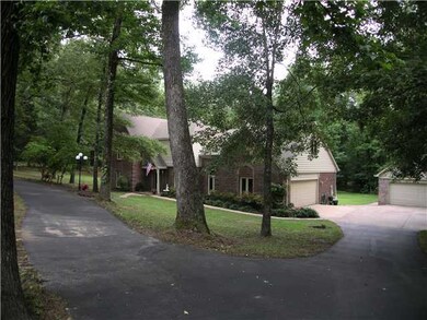 Majestic trees shade the home and help provide low
