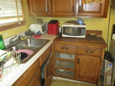 Kitchen with light tile patterned flooring and sin
