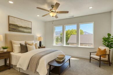 Bedroom with light carpet, ceiling fan, recessed lighting, and a mountain view