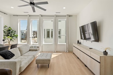 Living room with recessed lighting, visible vents, light wood-style flooring, and a ceiling fan