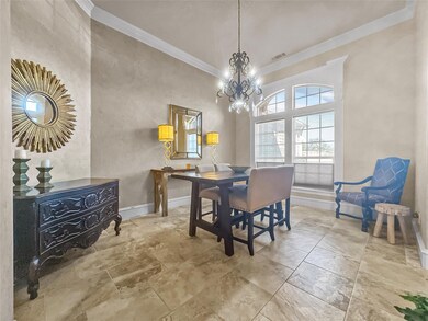 Dining space with ornamental molding, a chandelier