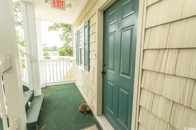 View of exterior entry featuring covered porch