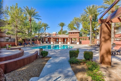 Community pool with fence and a patio area