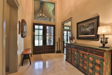 ENTER THE HOME THROUGH THE CUSTOM ALDER WOOD DOUBLE DOORS INTO THE 2 STORY ENTRY!