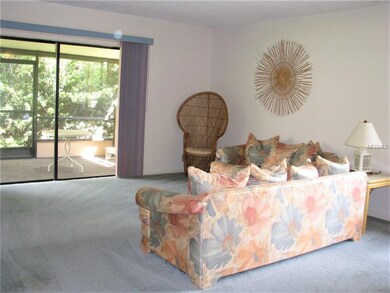 Spacious living room with sliders leading to the b