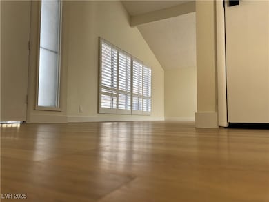 Spare room with lofted ceiling with beams and base