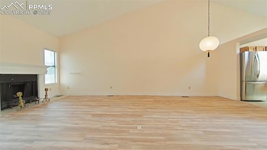 Unfurnished living room with a fireplace, high vau