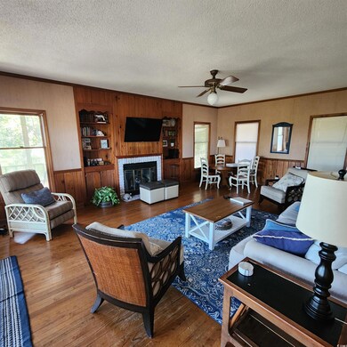 Living room featuring a textured ceiling, hardwood