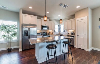 Kitchen featuring a sink, a kitchen island, stain