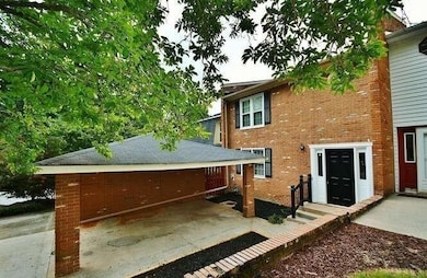Rear view of property with brick siding