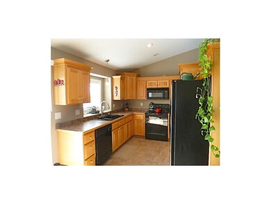 Lots of cabinets and counter space, black applianc