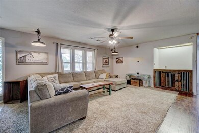 Living room featuring a textured ceiling, ceiling 