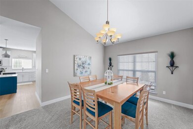 Dining room has vaulted ceiling, double window and