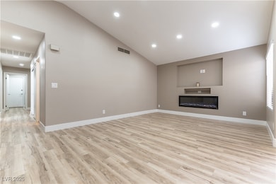 Living room featuring LED fireplace and niche for