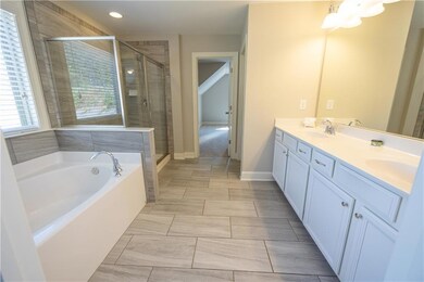 Full bathroom with a sink, a shower stall, double 