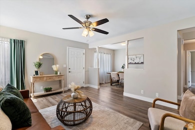Living area featuring wood finished floors and ceiling fan