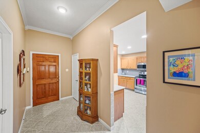 As you enter the home, the kitchen opens to your l