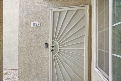Entrance to property with stucco siding