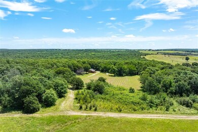 Overview of rural landscape featuring a heavily wooded area