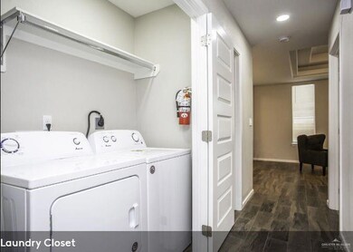 Laundry room with baseboards, washer and dryer, laundry area, dark wood finished floors, and recessed lighting
