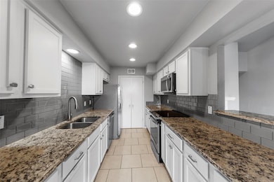 Kitchen with stainless steel appliances, visible v