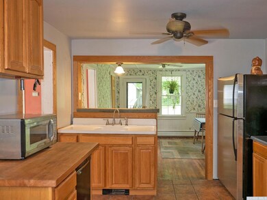 Kitchen with farm sink looking back to dining room