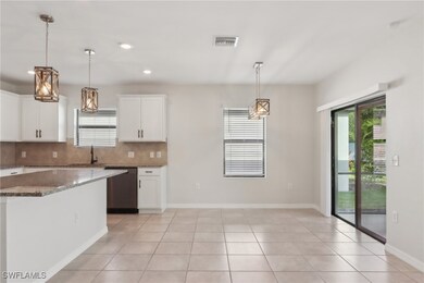 Kitchen with backsplash, white cabinetry, dishwash