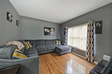 Living area featuring light wood finished floors and baseboards