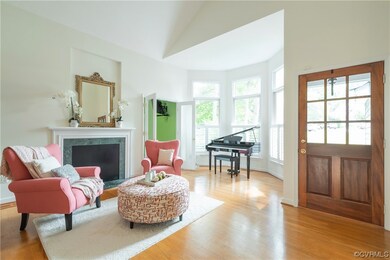 Foyer & living room area welcomes guests, gorgeous wood door,
warm light envelops the room