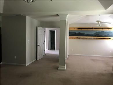 Basement featuring carpet floors and ceiling fan
