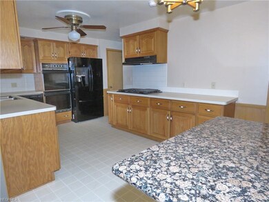 A granite kitchen island adds additional food prep