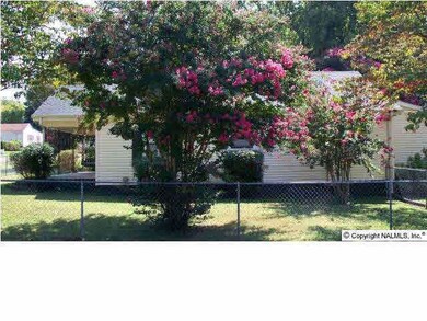 Side view of the home. There are plenty of trees in the yard, including the beautiful crepe myrtles.