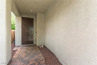 Doorway to property featuring stucco siding
