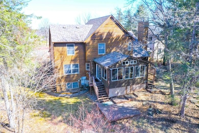 Rear view of property featuring a chimney, a shing