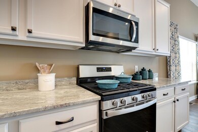 A closer look at the cooking setup - the micro hood does vent outside. Model photo, colors and selections may vary.