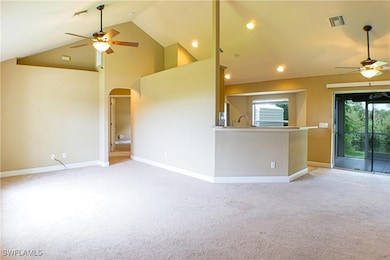 Unfurnished living room with ceiling fan, arched w