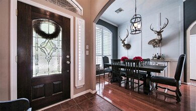 Right off the foyer, is the formal dining room featuring wood paneling on the walls and a custom built in buffet! A true show of gorgeous workmanship!