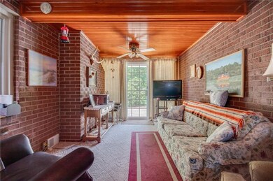 Finished breezeway boasts wood ceiling and exposed