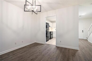 Unfurnished dining area with stairway, a chandelie