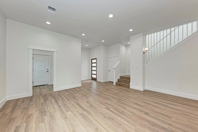 Unfurnished living room featuring stairs, recesse