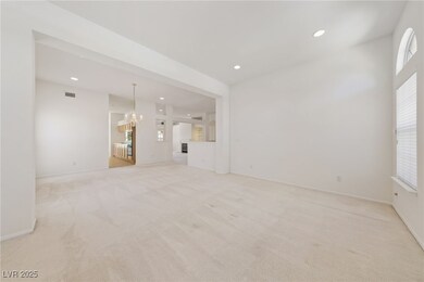 Unfurnished living room featuring a chandelier, li