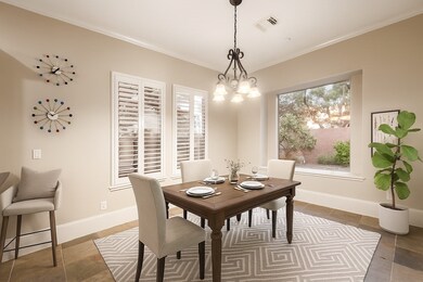 Breakfast nook has plenty of space and natural light. This photo has been digitally staged.