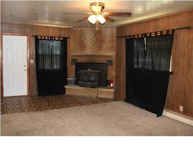 LARGE LIVING ROOM FEATURES A WOODBURNING FIREPLACE