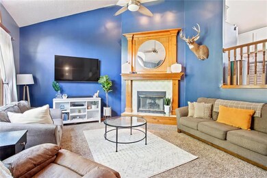 The living room with soaring ceilings and fireplac